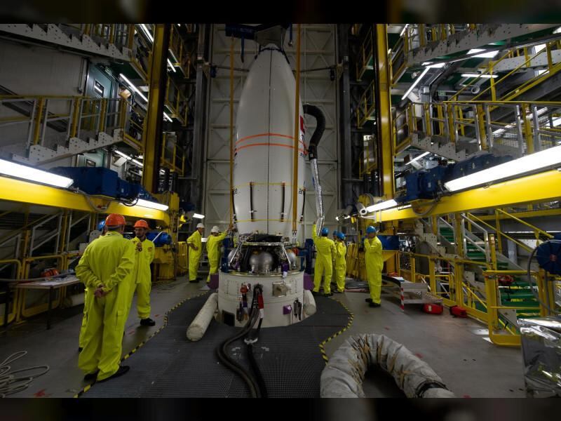 Engineers stand around the Vega rocket that will launch FalconEye1 into space. Wam