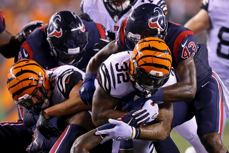 Cincinnati Bengals running back Jeremy Hill is tackled by Houston Texans strong safety Corey Moore. Aaron Doster-USA TODAY Sports