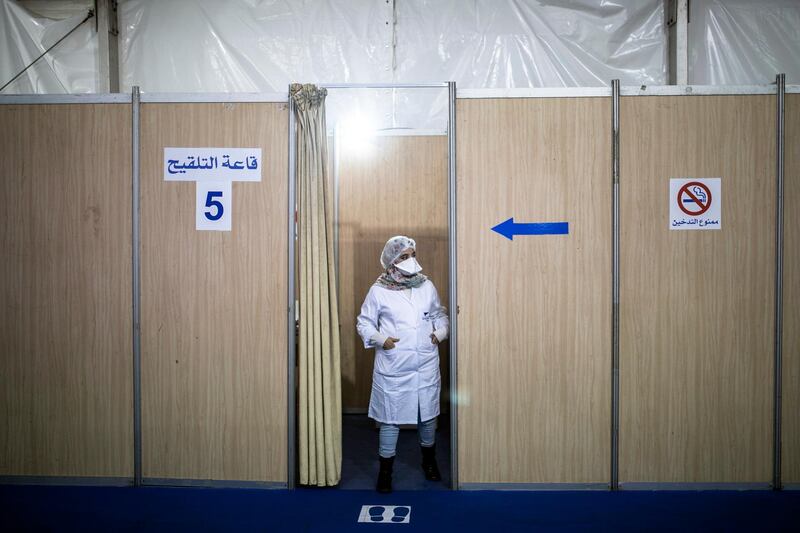 A nurse waits inside a vaccination booth before administering doses of the AstraZeneca-Oxford Covid-19 vaccine to health workers in Rabat. AP Photo