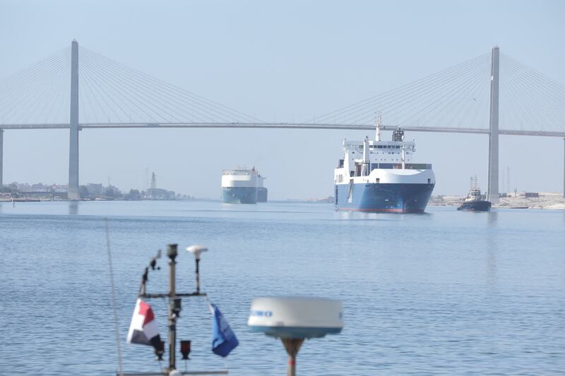 Container ships pass under the Suez Canal Bridge. A tugboat sank in the canal on Saturday after colliding with a Hong Kong-flagged tanker. Reuters