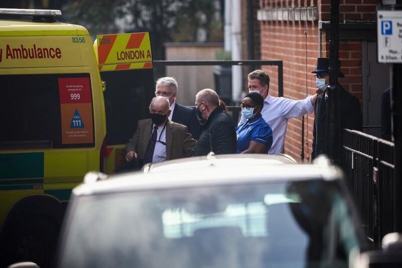 Hospital staff stand next to an ambulance outside King Edward VII's Hospital. Reuters