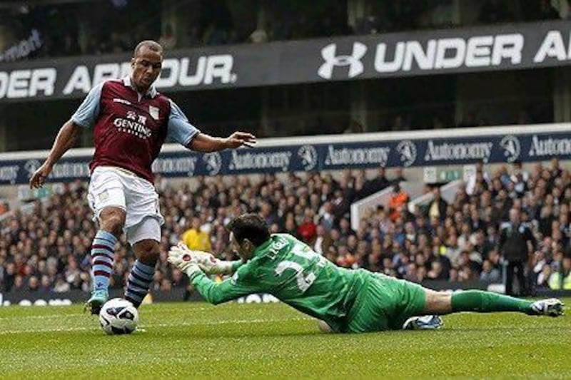 Tottenham Hotspur's French goalkeeper Hugo Lloris (R) dives at the feet of Aston Villa's English striker Gabriel Agbonlahor (L) during the English Premier League football match between Tottenham Hotspur and Aston Villa at White Hart Lane in north London, England on October 7, 2012. AFP PHOTO/IAN KINGTON