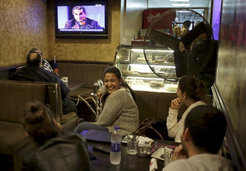 Egyptians watch the weekly programme of Bassem Youssef, the man known as “Egypt’s Jon Stewart,” at a coffee shop in Cairo. Khalil Hamra / AP





