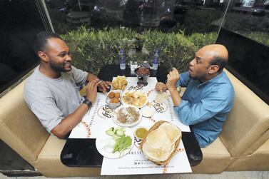 Co-owner Mujahed Salah from Al Mufraka restaurant speaks with Saeed Saeed about Sudanese food. Chris Whiteoak / The National