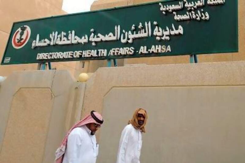 Saudi men walk to the King Fahad Hospital in the city of Hofuf, some 370 kilometres East of the capital Riyadh, where outbreaks of the Mers virus have been most concentrated.