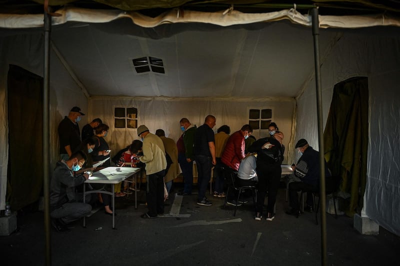 People inside a tent fill in forms prior being vaccinated during the vaccination marathon at Bran Castle. AFP