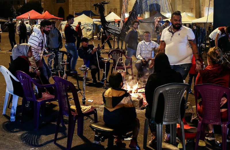 Protesters gather around a fire to warm as they smoke Shisha at Martyrs' Square in downtown Beirut.  EPA
