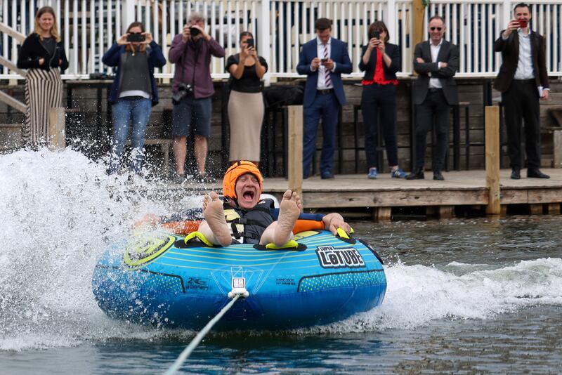 Mr Davey rides a towable inflatable during a visit to Lakeside Ski & Wake, in the Cotswolds. Reuters