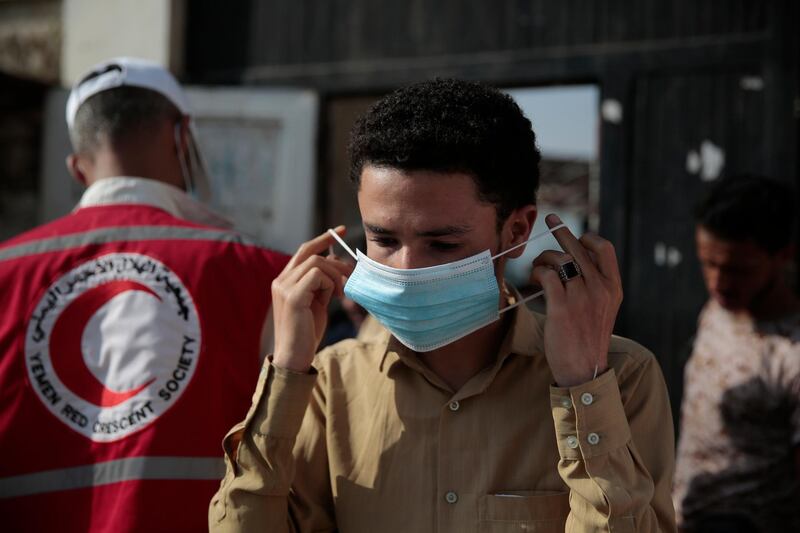 A Yemen student wears face mask to help curb the spread of coronavirus before taking a final-term school exam at a public school in Sanaa, Yemen. AP Photo