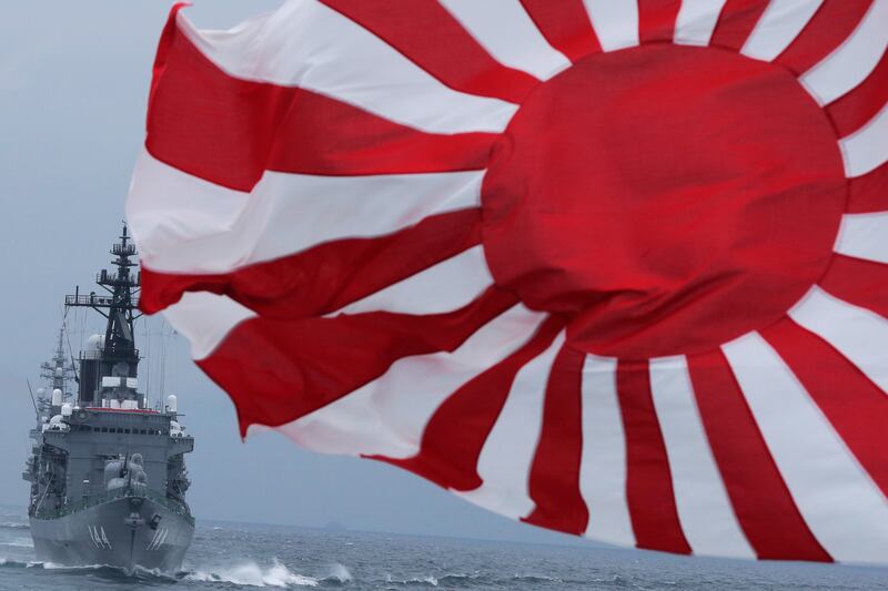 Japan Maritime Self-Defence Force escort ship Kurama navigates behind destroyer Yudachi with a rising sun flag. AP