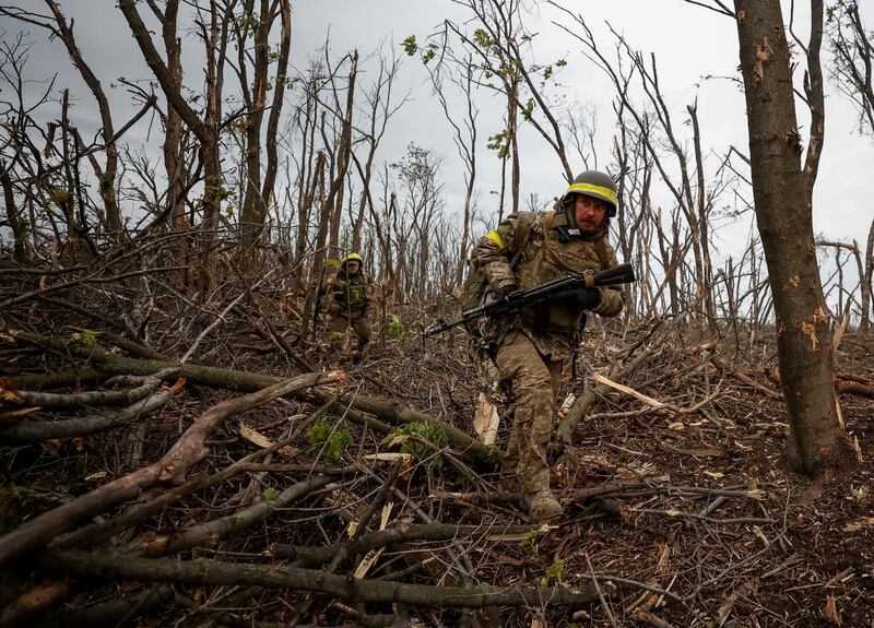 Ukrainian servicemen check Russian positions near the front-line city of Bakhmut. Reuters