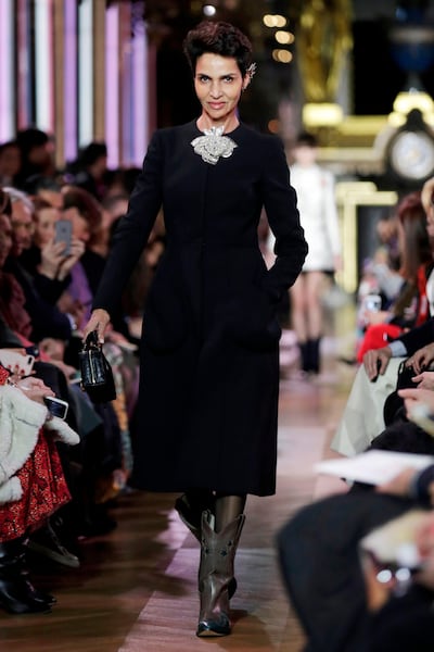 French-Algerian actress Farida Khelfa presents a creation by Schiaparelli during the 2019 Spring-Summer Haute Couture collection fashion show in Paris, on January 21, 2019. / AFP / Thomas SAMSON
