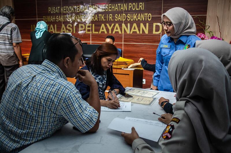 Families submit documents of their lost relatives victims of the crash. Getty Images