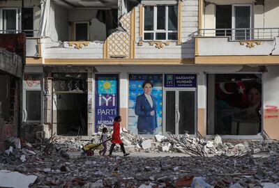 People walk in front of a picture of Turkish oppoisiton IYI Parti party leader Meral Aksener in Nurdagi district of Gaziantep, Turkey. EPA