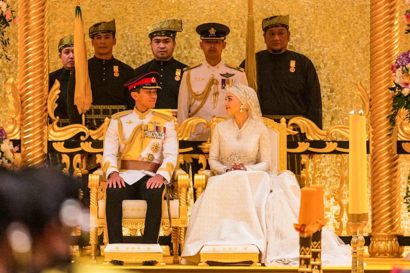 Prince Abdul Mateen and Yang Mulia Anisha Rosnah sit during their wedding reception at Istana Nurul Iman in Brunei's capital Bandar Seri Begawan on January 14, 2024.  (Photo by Iqbal Dato Hj Selamat  /  AFP)