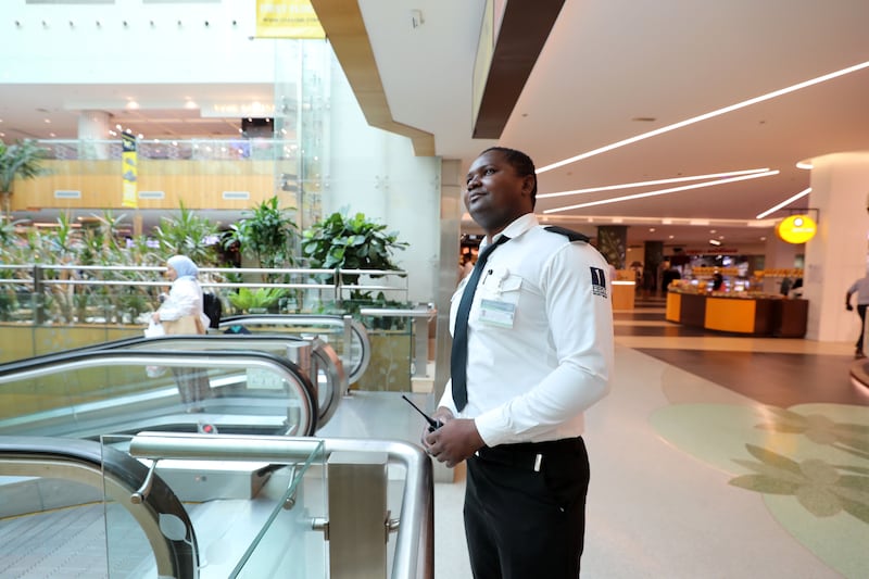 A security guard works without a mask in the Times Square Centre after safety measures were lifted last September. Dubai. Chris Whiteoak / The National