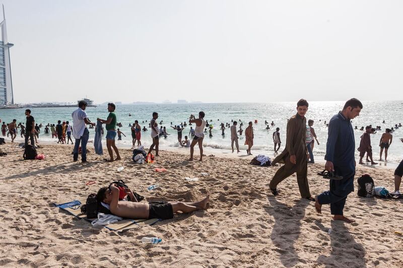 DUBAI, UNITED ARAB EMIRATES, 26 JUNE 2017. Dubai residents take advantage of the second day of Eid public holiday to enjoy the plentiful sunshine at the Jumeirah sunset beach. (Photo: Antonie Robertson/The National) ID: None. Journalist: None. Section: National. *** Local Caption ***  AR_2606_Eid_Beach-08.JPG