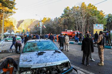 This picture shows people and Iranian emergency personnel at the where two explosions in quick succession struck a crowd marking the anniversary of the 2020 killing of Guards general Qasem Soleimani, near the Saheb al-Zaman Mosque in the southern Iranian city of Kerman on January 3, 2024.  Iran's president Ebrahim Raisi condemned on January 3 twin blasts that killed at least 103 people in the country's south where crowds gathered to mark the killing of general Qasem Soleimani.  (Photo by Sare Tajalli  /  ISNA  /  AFP)