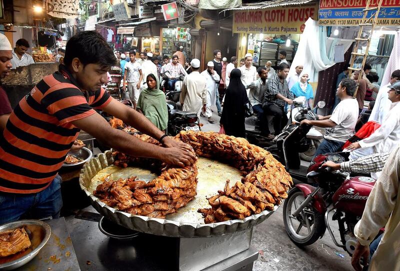 There are flat metal trays piled high with samosas, the triangles of pastry filled with meat or potatoes; saucers of sliced fruit, sprinkled with salt and pepper; pieces of deep fried chicken, still sizzling as scooped out of the oil and ladled onto plates. Harish Tyagi/EPA