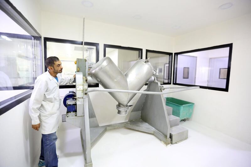 A laboratory technician stands next to drug-making machine at the Syrian Tamico Pharmaceutical Factory in Damascus. The factory is producing Azithromycin tablets, which are used with hydroxychloroquine as one of the treatments for patients with Covid-19, however a recent study revealed this combination may be associated with increased mortality. Youssef Badawi / EPA