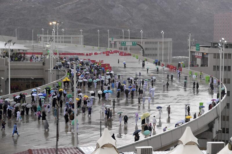 Muslim worshippers arrive in Mina under heavy rain to throw pebbles as part of the symbolic Jamrat Al Aqabah. AFP