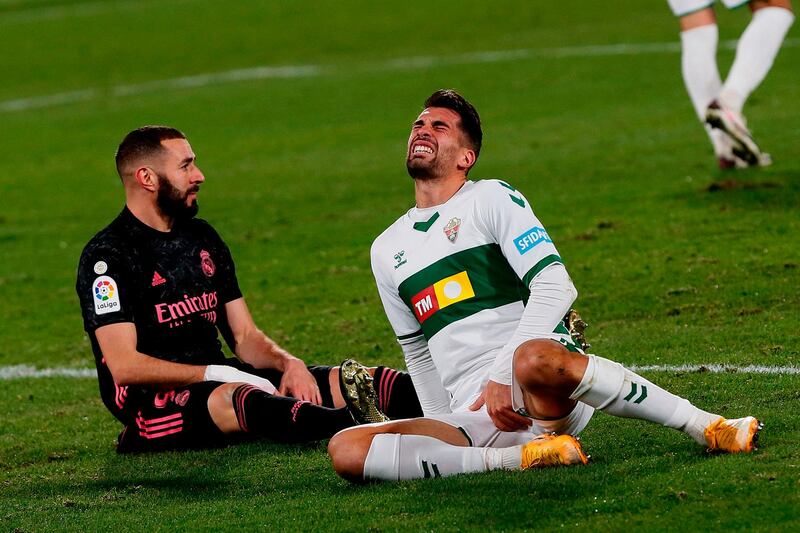 Real Madrid's Karim Benzema and Elche's Josema react after falling. AFP