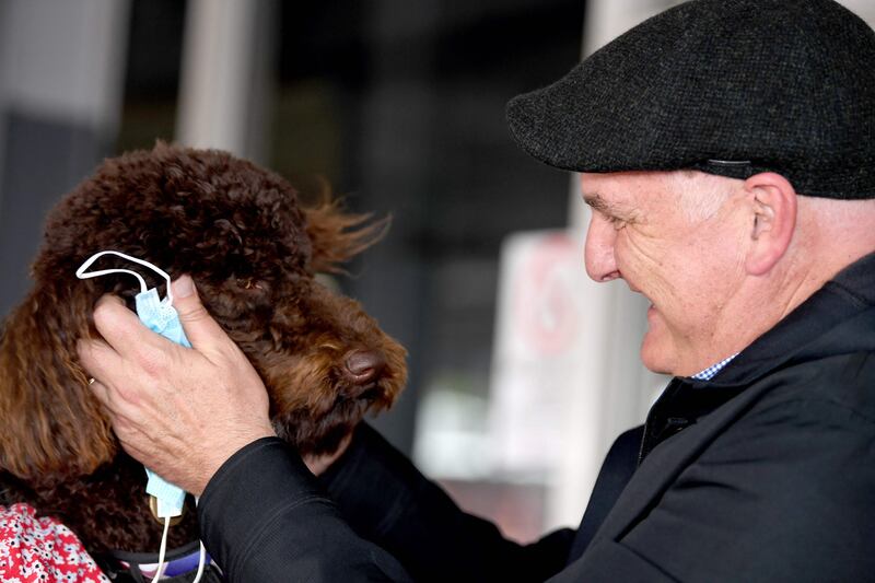 Sydney’s international airport hosted tearful reunions, such as this one of a man and his pet. AFP