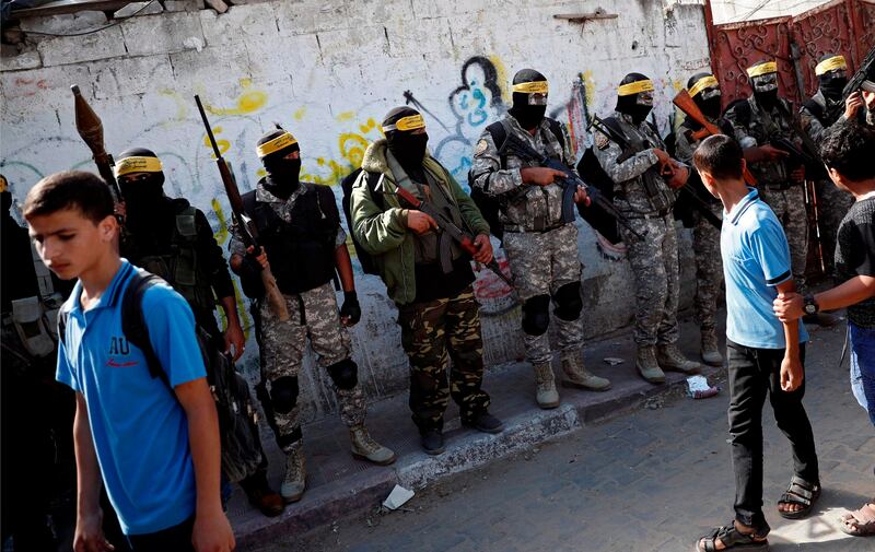 Members of the Palestinian Islamic Jihad Movement and masked militants attend the funeral of comrades killed in an Israeli operation to blow up a tunnel stretching from the Gaza Strip into Israel during their funeral in the Bureij refugee camp, in central Gaza, on October 31, 2017. 
Seven Palestinians were killed as Israel blew up what it said was a tunnel stretching from the Gaza Strip into its territory, a rare case of such an incident since a devastating 2014 war. / AFP PHOTO / THOMAS COEX