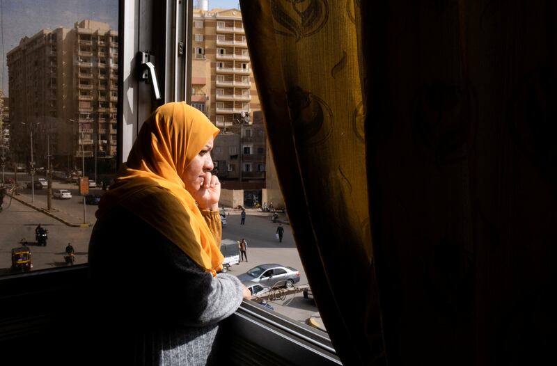 Samia Hassan, 38, from South Sinai, looks through her room's window, in Giza, Egypt, January 29, 2023.  Nahr el-Hub was set up by three female Egyptian retirees, to offer housing and support for cancer patients who are not residents of Cairo and were forced to come to the capital for treatment at the hospital.  REUTERS / Fatma Fahmy