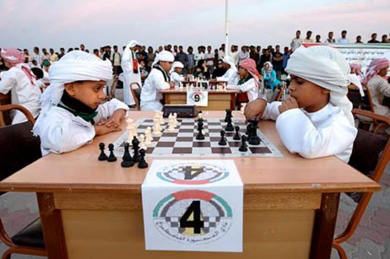 FUJAIRAH, UNITED ARAB EMIRATES Ð Dec 2: Left to Right- Sultan Abdul Aziz (9 years old) and Khalid Rashid Ahmed (11 years old) from Fujairah during the Chess competition held at the Fujairah Corniche as UAE celebrating it's 38th National Day in Fujairah.  (Pawan Singh / The National) For News. *** Local Caption ***  PS0212- NATIONAL DAY013.jpg