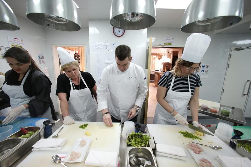 Phillip Harbin, chef de cuisine explains a technique to Mitra Birgani, left to right, Jayne Birgani and Rosemary Behan during a ceviche masterclass at Asia De Cuba. Christopher Pike / The National