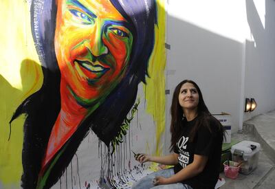 An Afghan artist paints an image of Afghan singer Ahmad Zahir during "The Sound Central Festival" at The French Cultural Centre in Kabul on October 4, 2012. More than a hundred artists attended the third edition of the festival, an event hosted by the centre, a unique gathering in Afghanistan, where music was banned by the Taliban until the end of 2001.    AFP PHOTO/Jawad Jalali (Photo by Jawad Jalali / AFP)