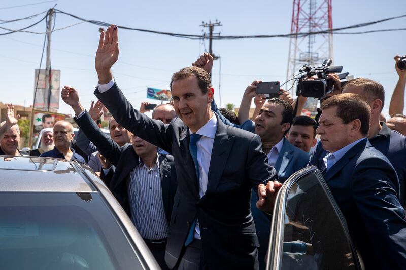 Syrian President Bashar Al Assad waves to supporters in the eastern Ghouta region near the Syrian capital of Damascus. It is 10 years since Syria was expelled from the Arab League. AP