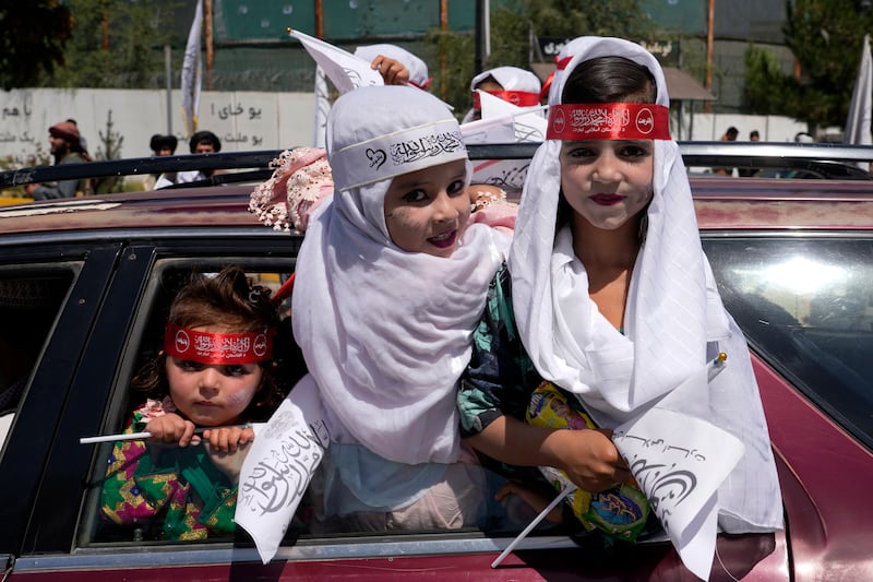Children with Taliban flags celebrate the anniversary. AP Photo