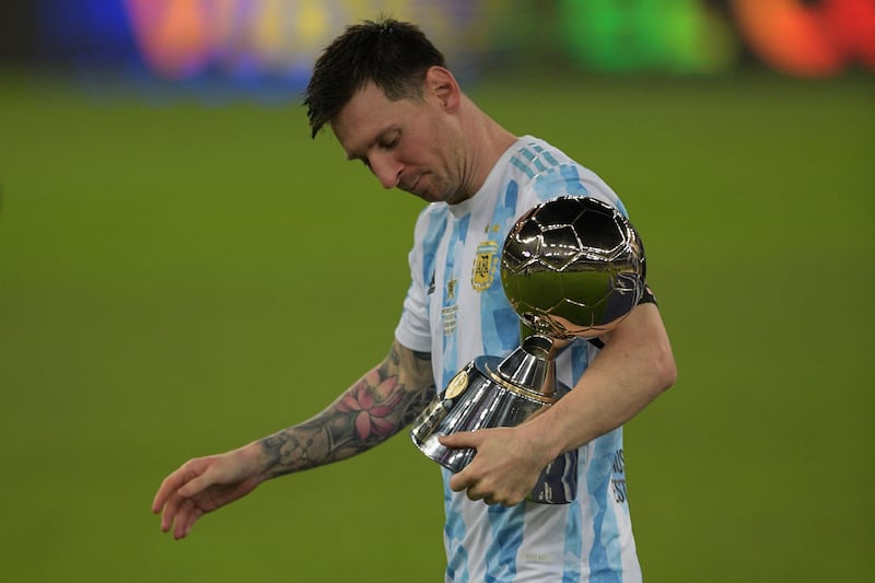 Lionel Messi holds the trophy for the championship's top scorer. AFP