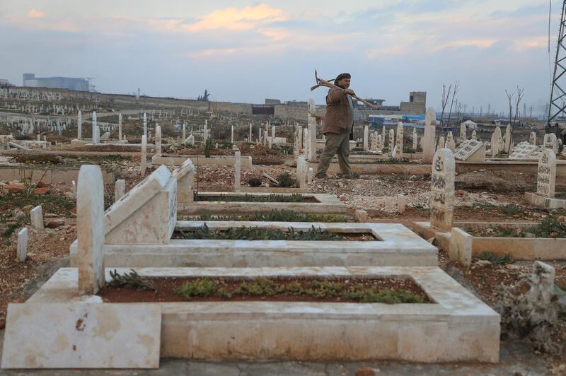 Idlib’s tombstones stretch as far as the eye can see, bathed in a soft orange light as the sun sets on the horizon.