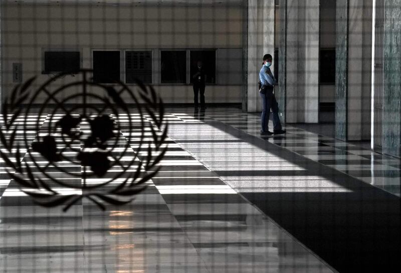 A UN police officer stands at an empty entrance at the United Nations. AFP