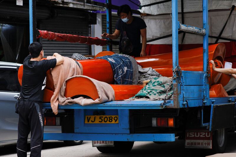 Workers move coffins as mortuaries run short of coffins amid lockdown in Shenzhen, China. Photo: Reuters