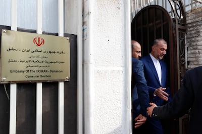 Iranian Foreign Minister Hossein Amirabdollahian, right, leaves after the opening of the new Iranian consulate building in Damascus on April 8. AP