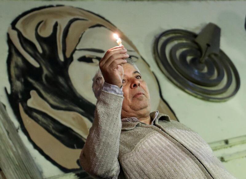 A man holds a candle in the memory of the victims of the attack in north Sinai, in front of the Press Syndicate in Cairo, Egypt, November 27, 2017. REUTERS/Mohamed Abd El Ghany