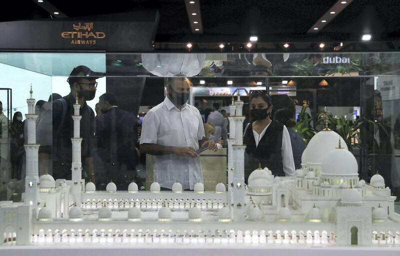 Visitors at the Abu Dhabi Stand looking at the model of Sheikh Zayed Grand Mosque at the Arabian Travel Market held at Dubai World Trade Centre in Dubai on May 16,2021. Pawan Singh / The National. Story by Deena