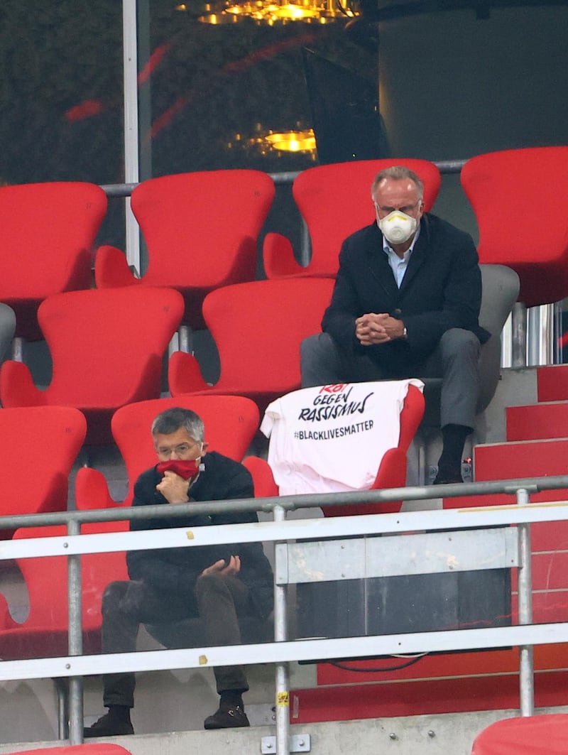 Bayern Munich CEO Karl-Heinz Rummenigge (R) and president Herbert Hainer sit in the stands. AFP