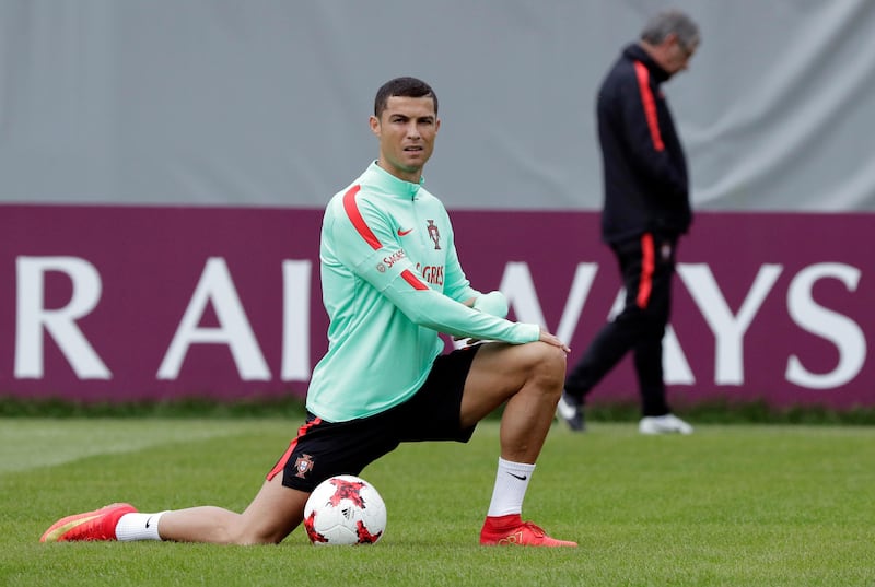 FILE - In this file photo dated Monday, June 26, 2017, Portugal's Cristiano Ronaldo stretches during a training session in St. Petersburg, Russia.  Spain's tax authority confirmed Wednesday July 12, 2017, that customs agents have boarded and carried out an inspection of a yacht rented by Portugal soccer captain Cristiano Ronaldo, adding that the inspection targeted the boat's owner, not Ronaldo as its renter. (AP Photo/Dmitri Lovetsky, FILE)