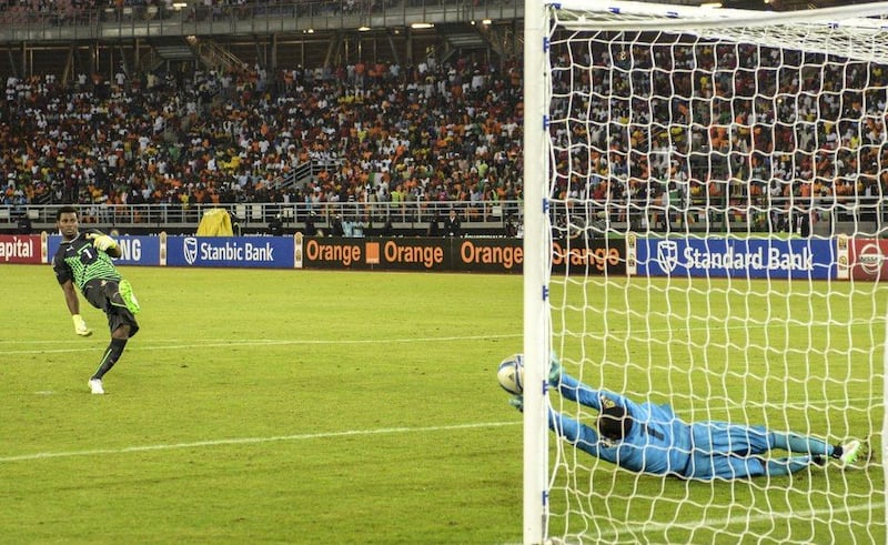 Goalkeeper Boubacar Barry of Ivory Coast, right, makes a save to give his team the edge against Ghana on Sunday in the Africa Cup of Nations final. Barry Aldworth / EPA
