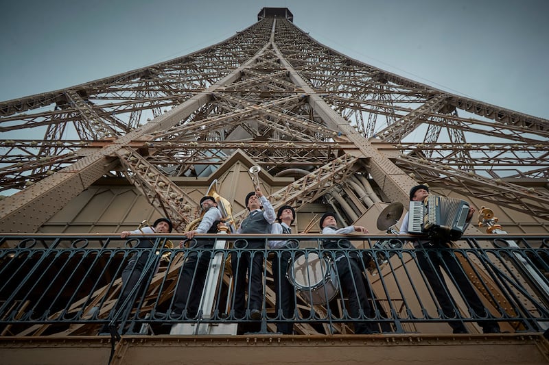 A brass band admires the view of Paris as the Eiffel Tower reopened for the first time in more than nine months. Getty Images