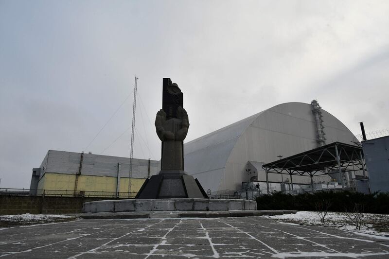 A monument in front of the giant protective dome built over the sarcophagus of the destroyed fourth reactor of Chernobyl nuclear power plant.  AFP