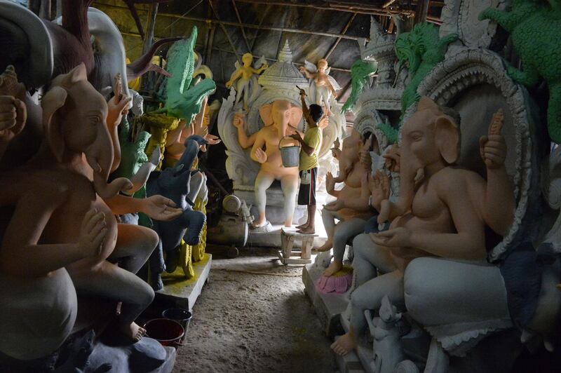 An Indian artist paints an eco-friendly figure of the Hindu deity Ganesh at a workshop in Hyderabad, ahead of the upcoming Ganesh Chaturthi celebrations. Noah Seelam / AFP