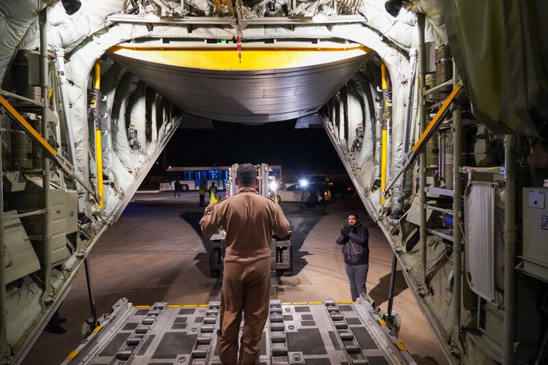 A UAE official manages the process from inside the plane