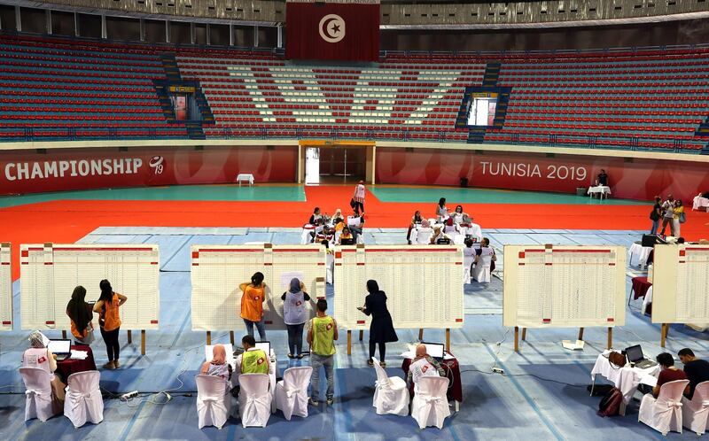 Tunisian electoral officials work at a vote counting center following the first round of presidential election in Tunis.  EPA