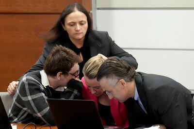 Nikolas Cruz, left, speaks with lawyers after Judge Elizabeth Scherer asked him if he was sure he wanted to rest his case. AP